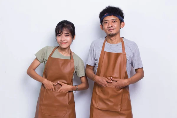 Portrait of Asian couple barista waiter wears apron standing with arms crossed isolated on white background