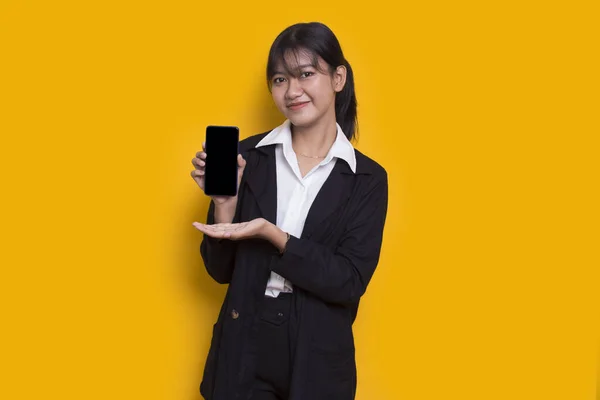 Asian Business Woman Demonstrating Mobile Cell Phone Isolated Yellow Background — Stock Photo, Image