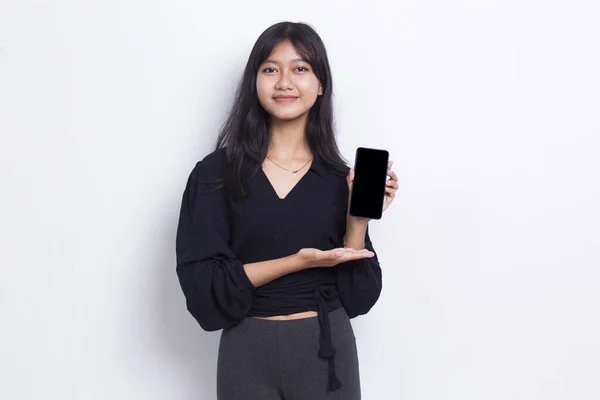 Young Beautiful Asian Cute Woman Demonstrating Mobile Cell Phone Isolated — стоковое фото