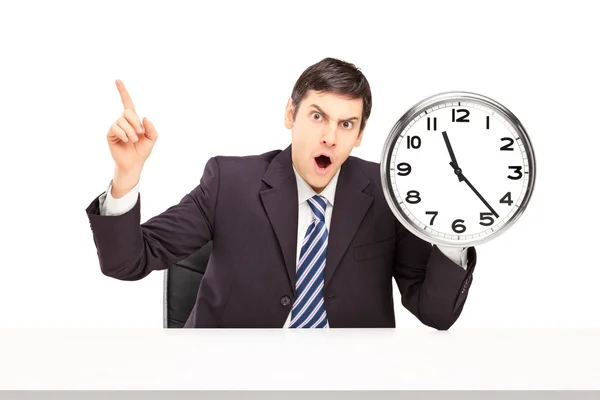 Businessman holding wall clock — Stock Photo, Image