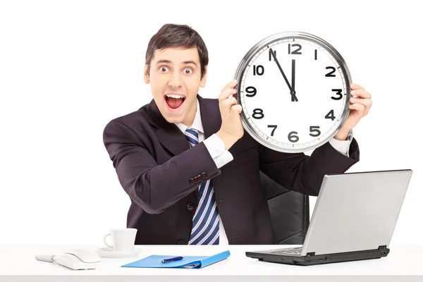 Happy businessman holding a clock — Stock Photo, Image