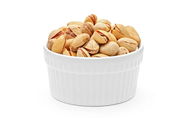 Salted and roasted pistachio nuts in a porcelain bowl — Stock Photo, Image