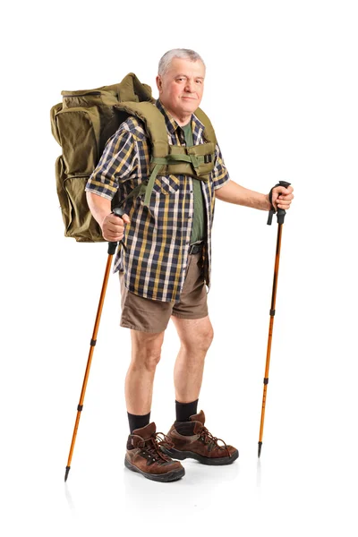 Mature holding hiking poles — Stock Photo, Image