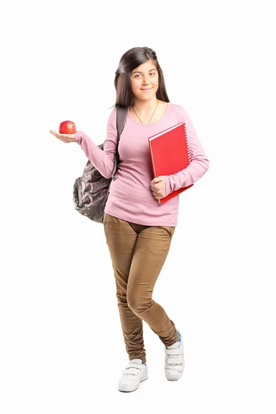 Colegiala sosteniendo una manzana — Foto de Stock