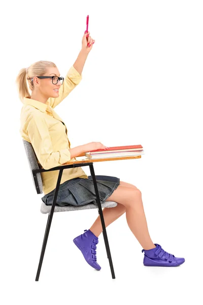 Female student raising her hand — Stock Photo, Image