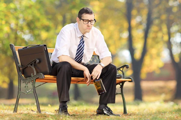Disappointed businessman on bench — Stock Photo, Image