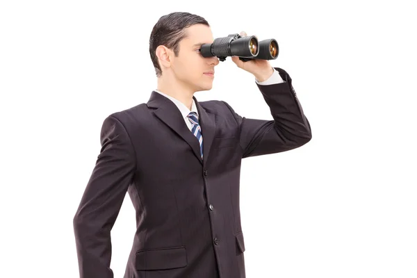 Businessman looking through binocular — Stock Photo, Image