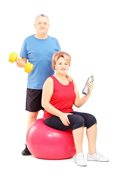 Man and woman with exercising equipment — Stock Photo, Image