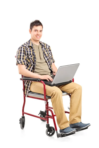 Homme en fauteuil roulant travaillant sur un ordinateur portable — Photo