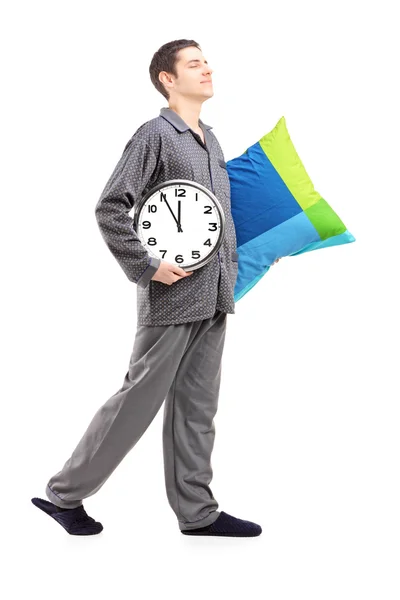 Man with pillow and clock — Stock Photo, Image