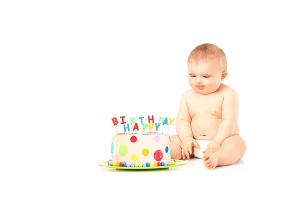 Un bambino di 9 mesi con i pannolini seduto accanto a una torta di compleanno — Foto Stock