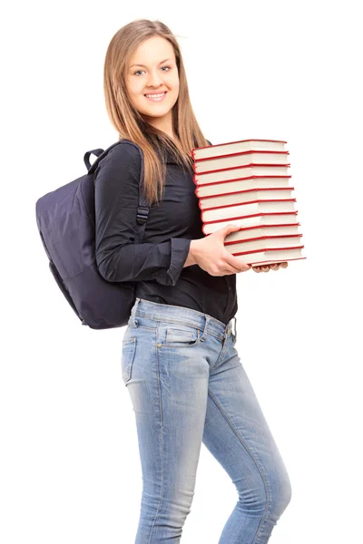 Student holding pile of books — Stock Photo, Image