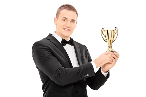 Young man in suit holding a trophy — Stock Photo, Image