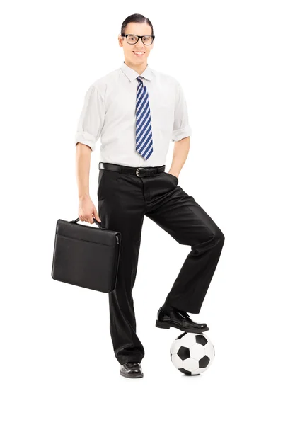 Businessman with football under foot — Stock Photo, Image