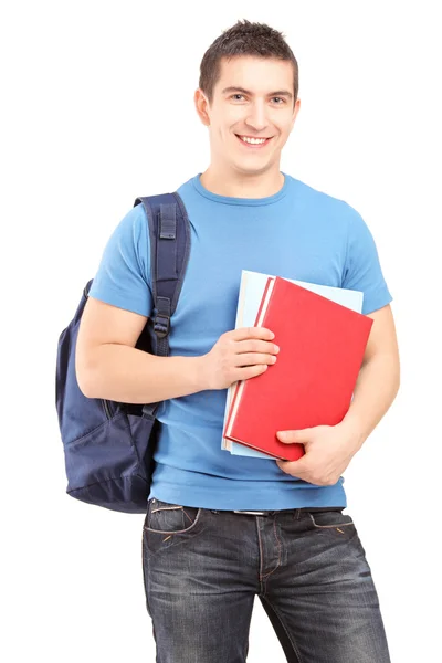 Estudante masculino segurando livros — Fotografia de Stock