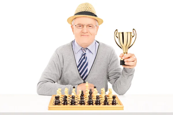 Senior chess player holding a trophy — Stock Photo, Image