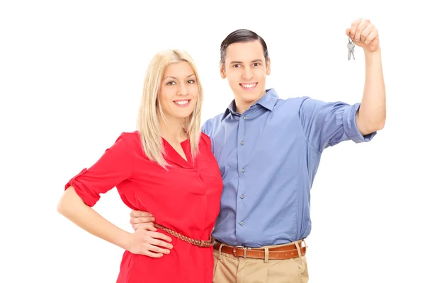 Happy young couple holding keys — Stock Photo, Image