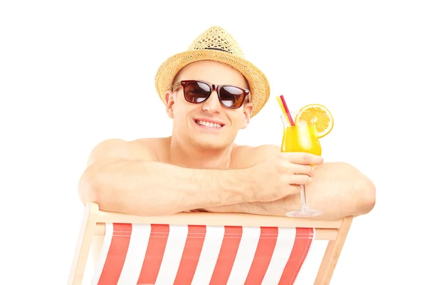 Man met cocktail op strandstoel — Stockfoto