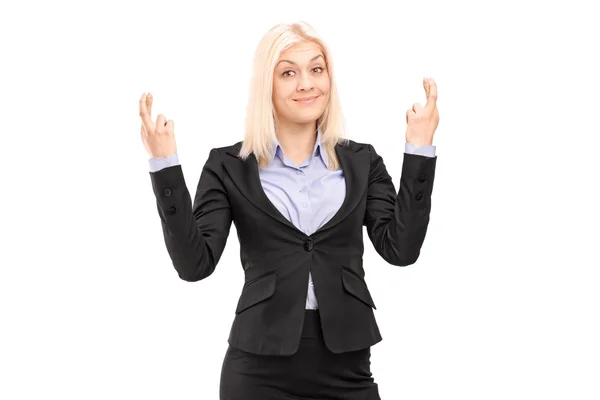Businesswoman posing with fingers crossed — Stock Photo, Image