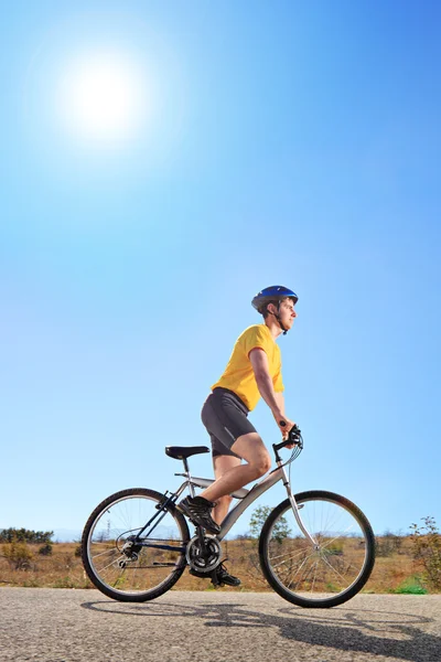 Male with helmet riding a bike — Stock Photo, Image