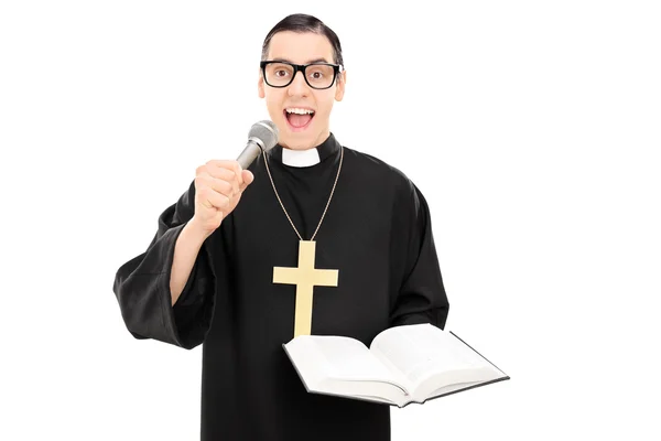 Priest reading prayer on microphone — Stock Photo, Image