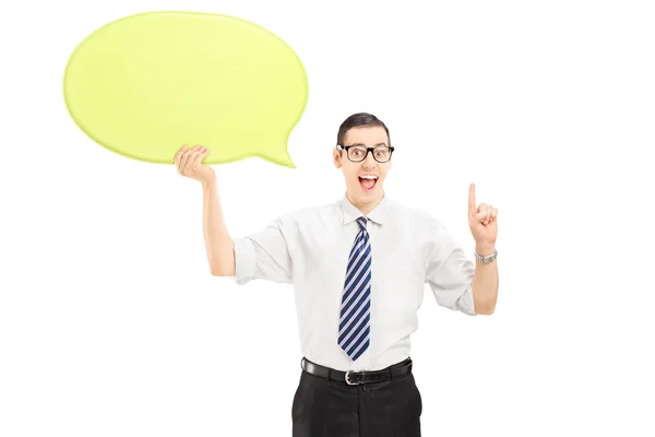 Young man holding a speech bubble — Stock Photo, Image