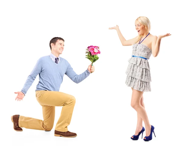 Male kneeling with flowers — Stock Photo, Image