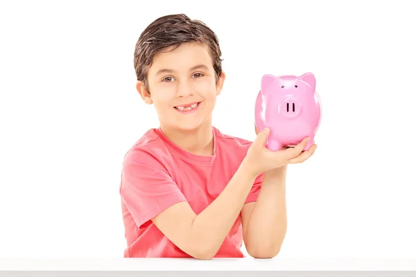 Little boy holding piggybank — Stock Photo, Image