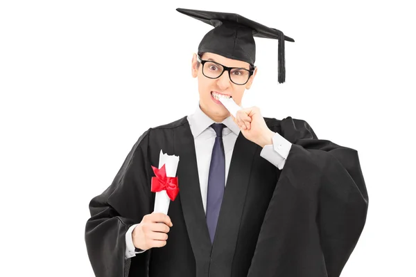 College graduate biting worthless diploma — Stock Photo, Image