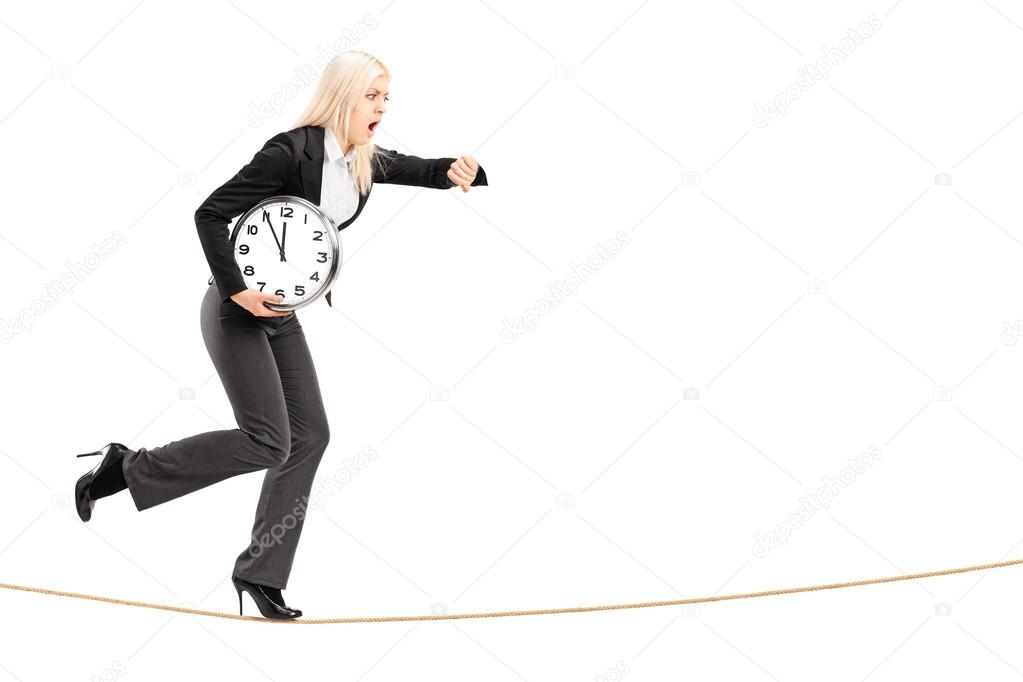 Businesswoman running late on rope