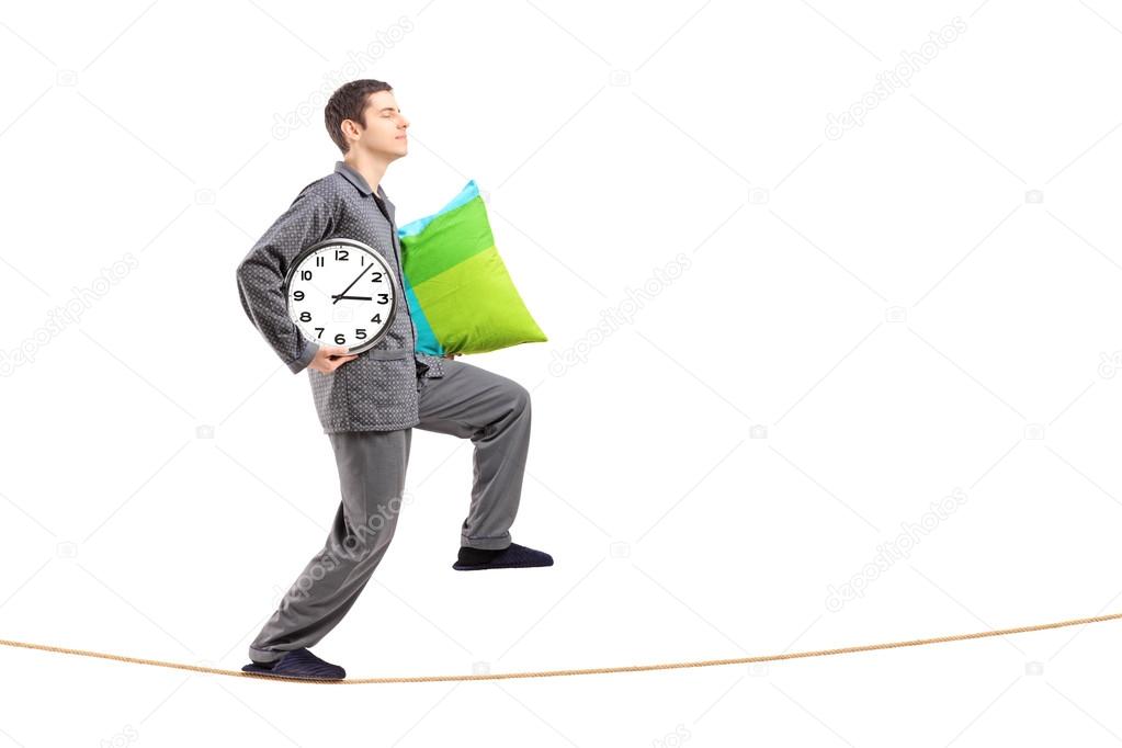 Man with pillow and clock
