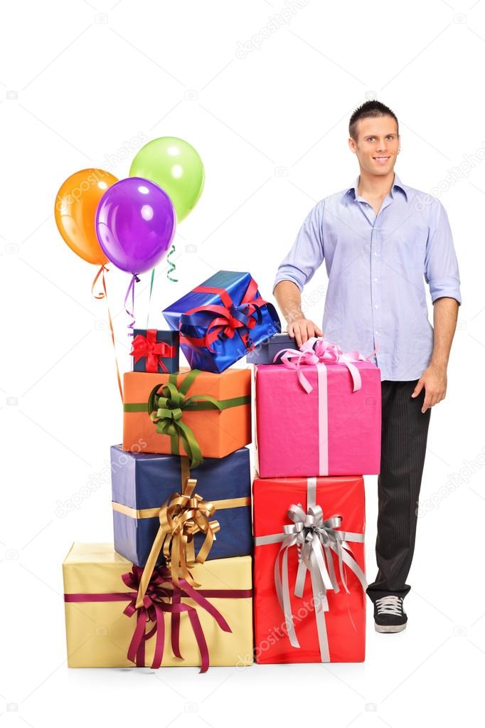 Man next to gifts and balloons