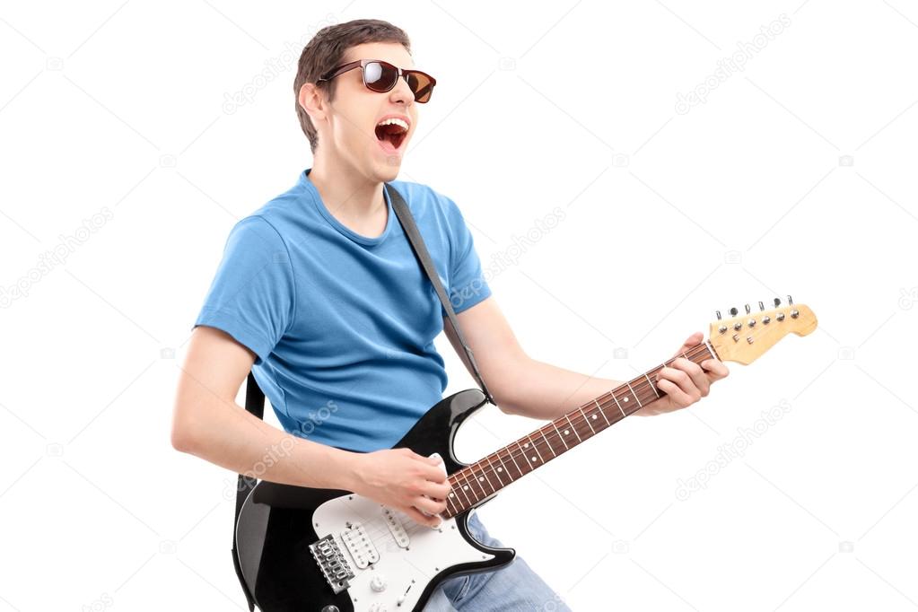 Guy playing on an electric guitar
