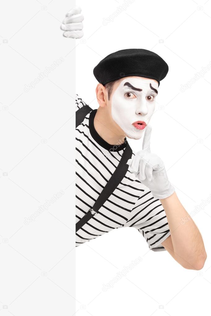 Male mime artist gesturing silence