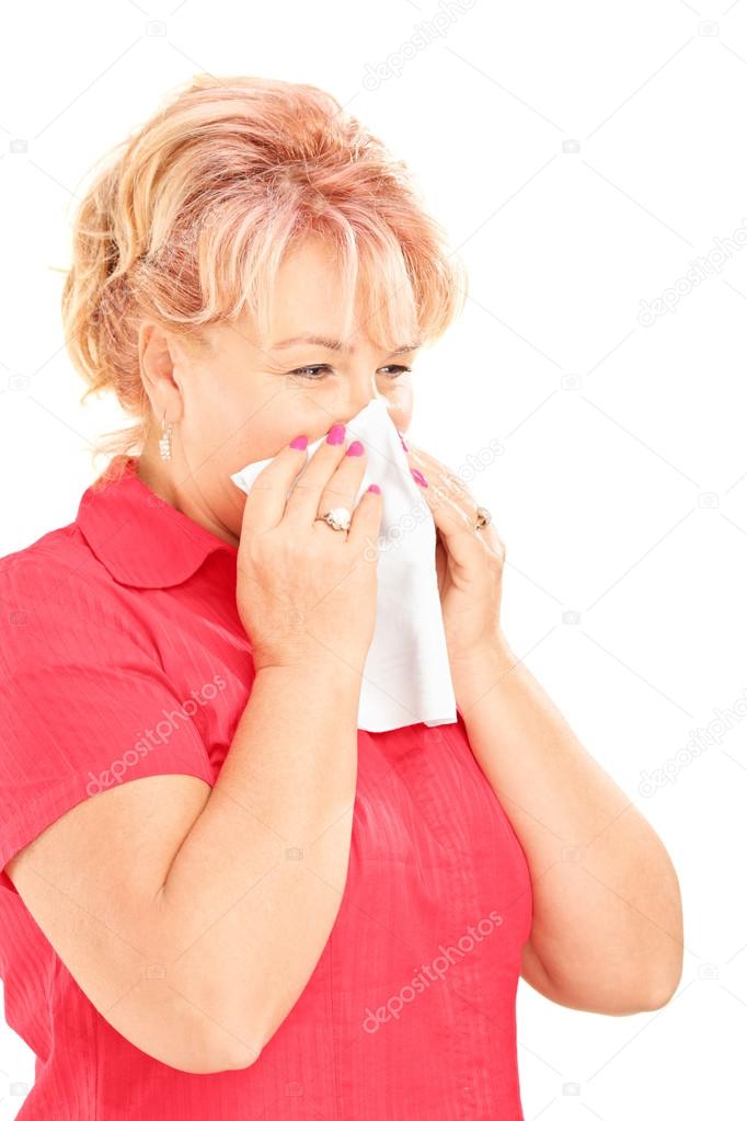 Mature woman blowing her nose
