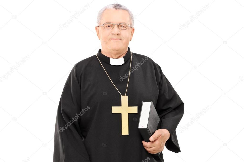 Mature priest holding bible