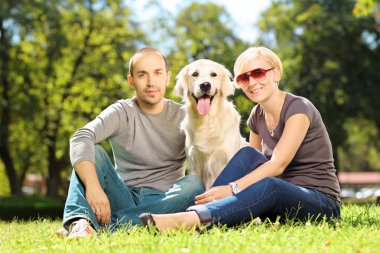 Young couple hugging a dog clipart