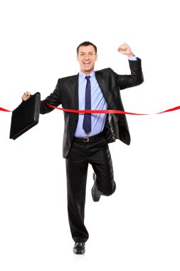 Businessman running at finish line clipart