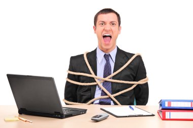 Businessman tied up with rope in the office clipart