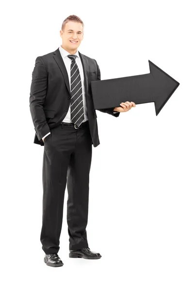 Businessman holding big arrow — Stock Photo, Image