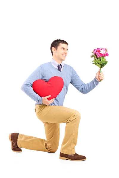 Male kneeling with flowers — Stock Photo, Image