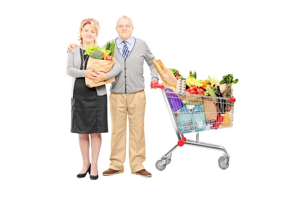 Man and woman holding shopping cart — Stock Photo, Image