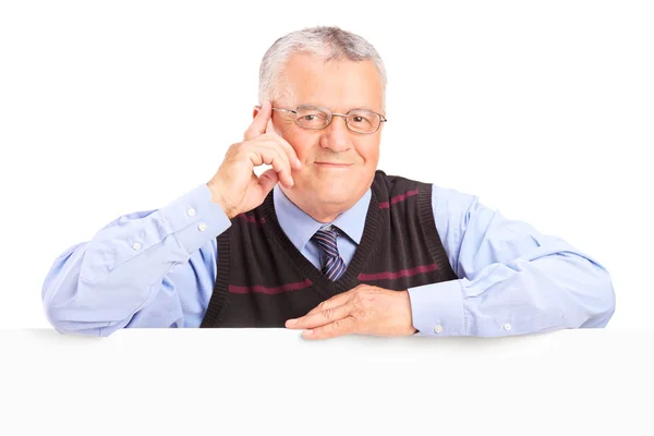 Senior man posing behind blank panel — Stock Photo, Image