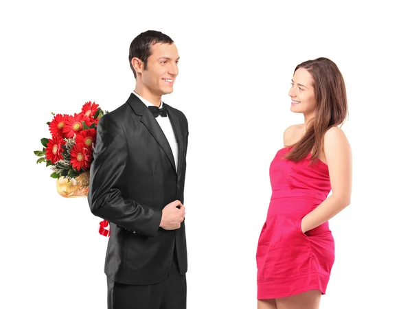 Man hiding flowers from woman — Stock Photo, Image