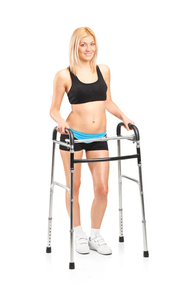 Young woman using walker — Stock Photo, Image