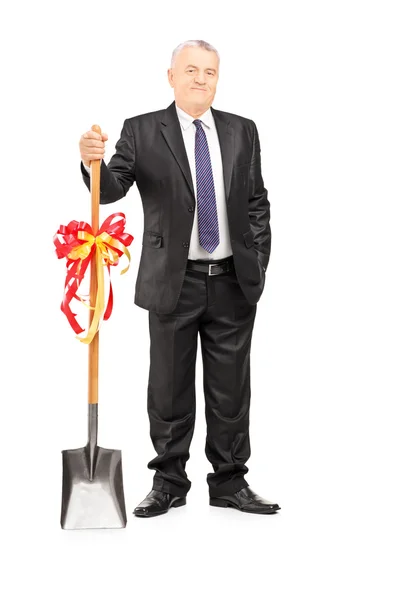 Investor holding shovel with ribbon — Stock Photo, Image