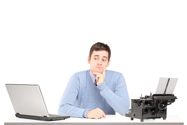 Uomo confuso con laptop e macchina da scrivere — Foto Stock