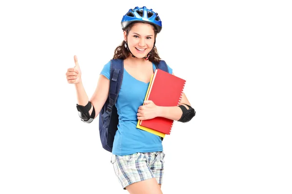 Menina em rolos segurando cadernos — Fotografia de Stock