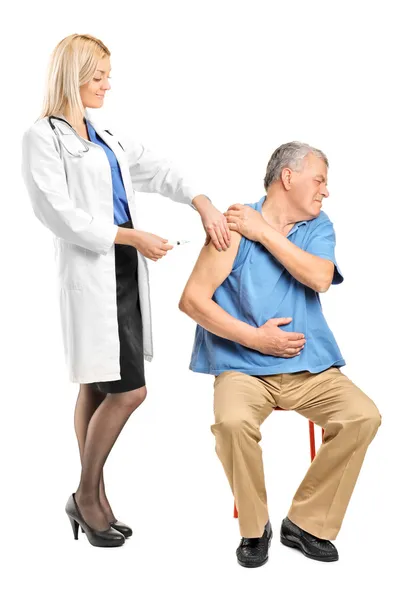 Doctor applying syringe to man — Stock Photo, Image