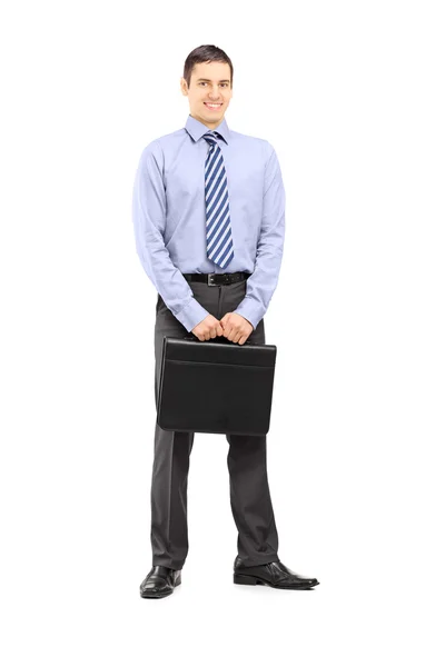 Smiling businessman holding a leather — Stock Photo, Image